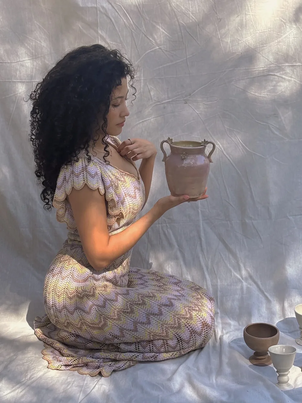 Nancy holding a finished piece in sunlight
