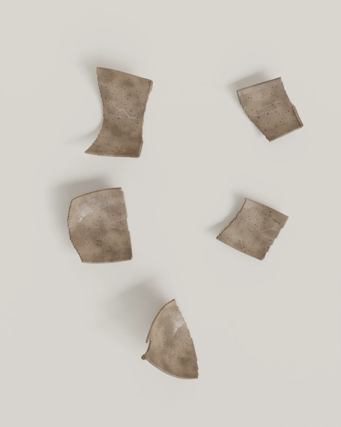 Finds tray — five stoneware fragments of the Dragon Fruit goblet laid out on bone linen after washing